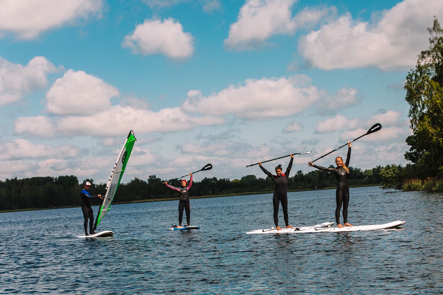 Paddleboarders and a windsurfer on Lake Nõuni
