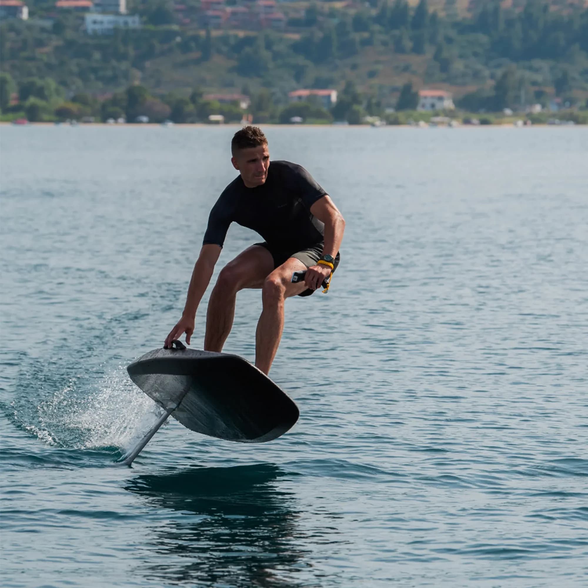 Rider gliding above the water on an eFoil at Lake Nõuni