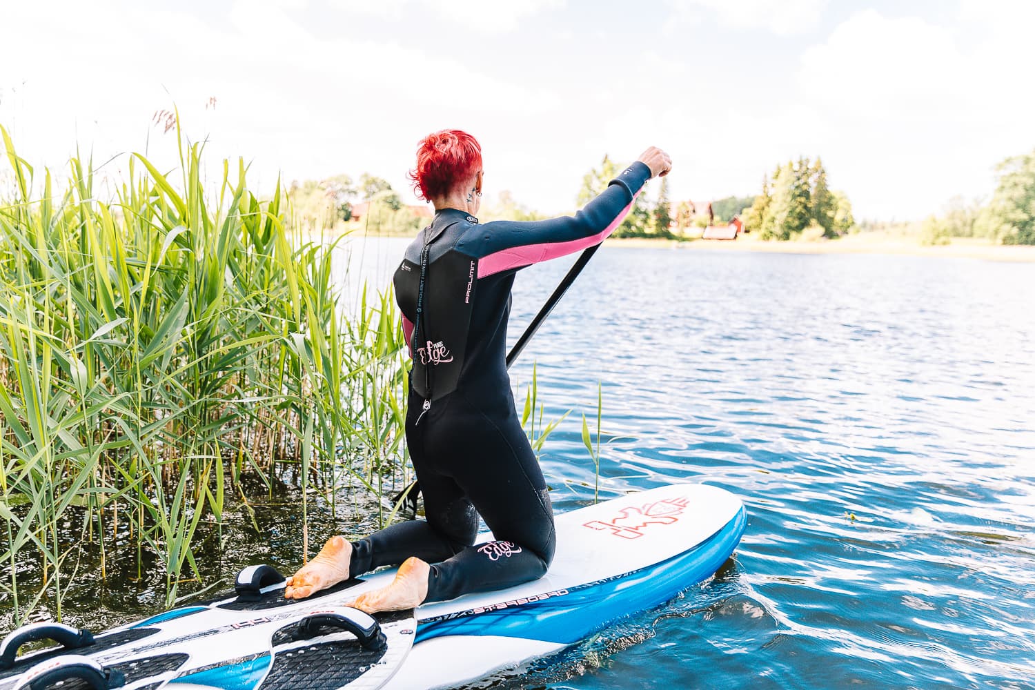 Paddling a SUP board out from the reeds on Lake Nõuni